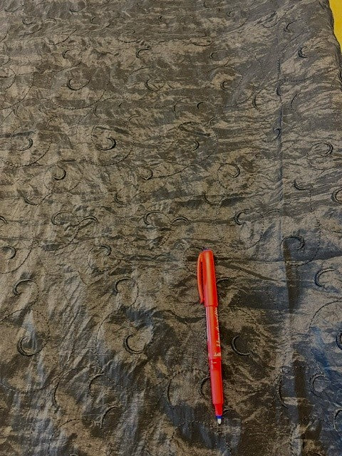 Black Crinkle Taffeta With Self Coloured Embroidery. 50% Nylon 50% Polyester. 120g/m2, 145cm Wide. Roll Size: 2.5m