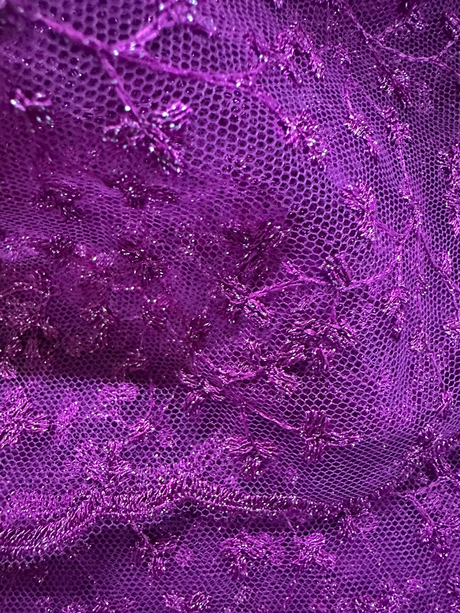 Close-up of purple lace fabric with intricate patterns