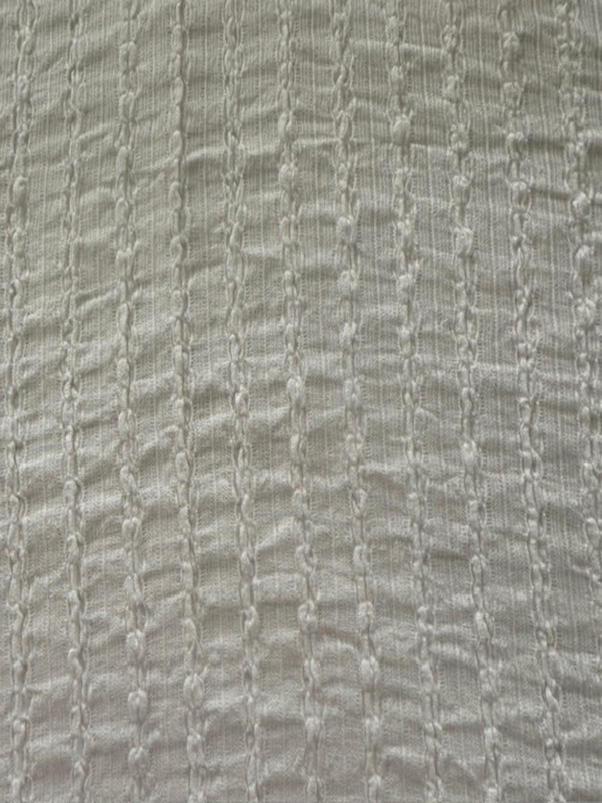 Ivory Textured Irregular Self Colour Stripe. Stripes run along the fabric.