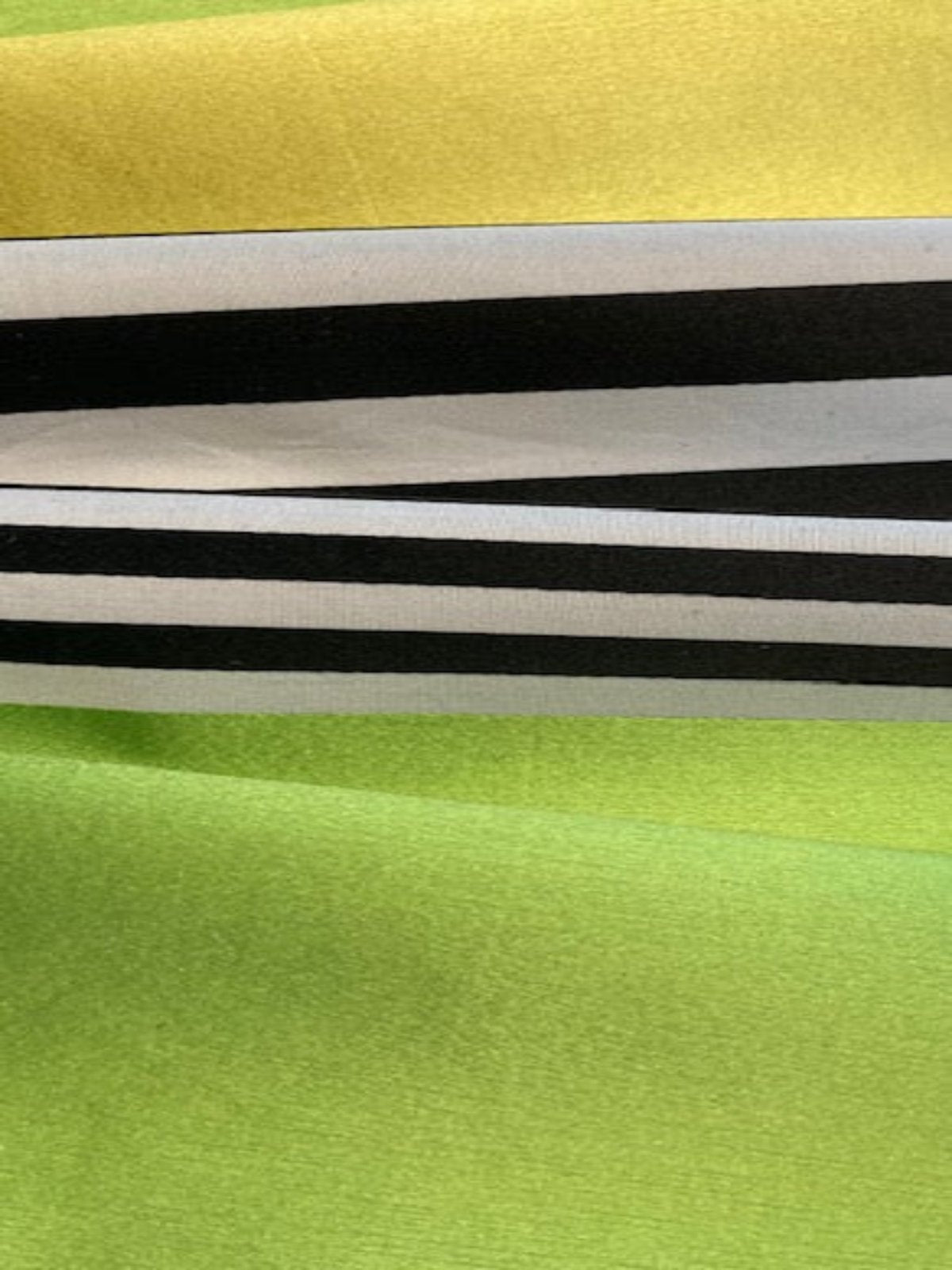 Lemon/Lime/Black Stripes Satin Faced. Stripes run along the Fabric