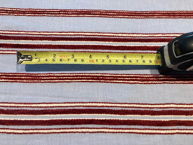 Red Raised Stripe on Sky Blue. Soft Handle, Stripes run across the fabric.