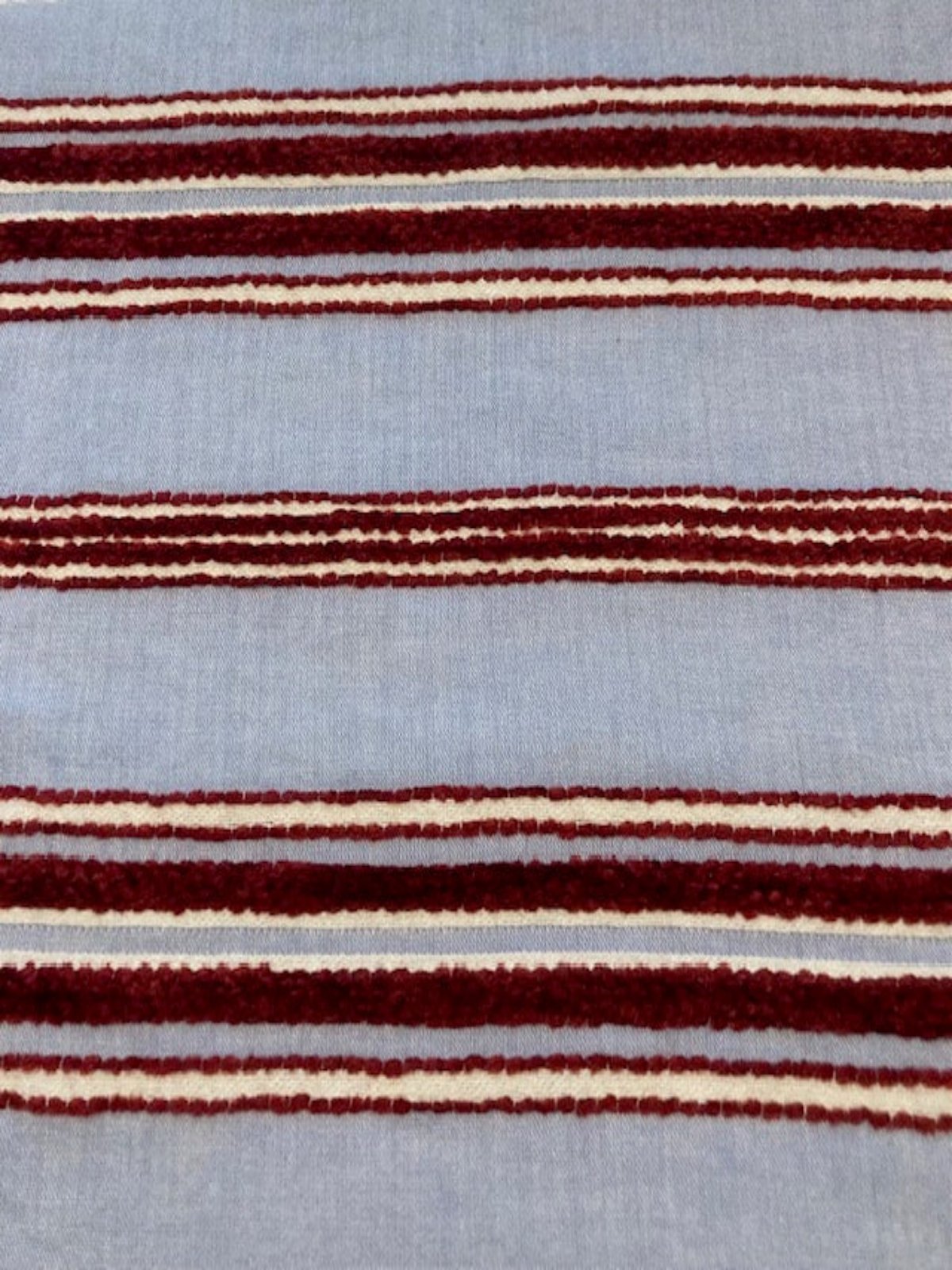 Red Raised Stripe on Sky Blue. Soft Handle, Stripes run across the fabric.