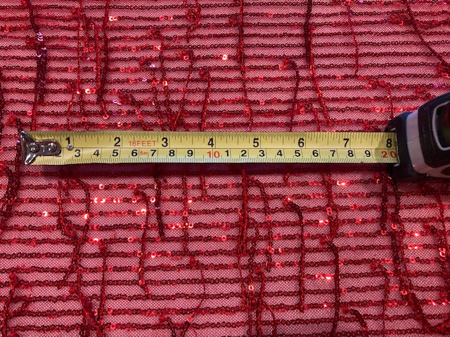 Red Sequin Tassel on Red Stretch Tulle. Tassels run across the piece.