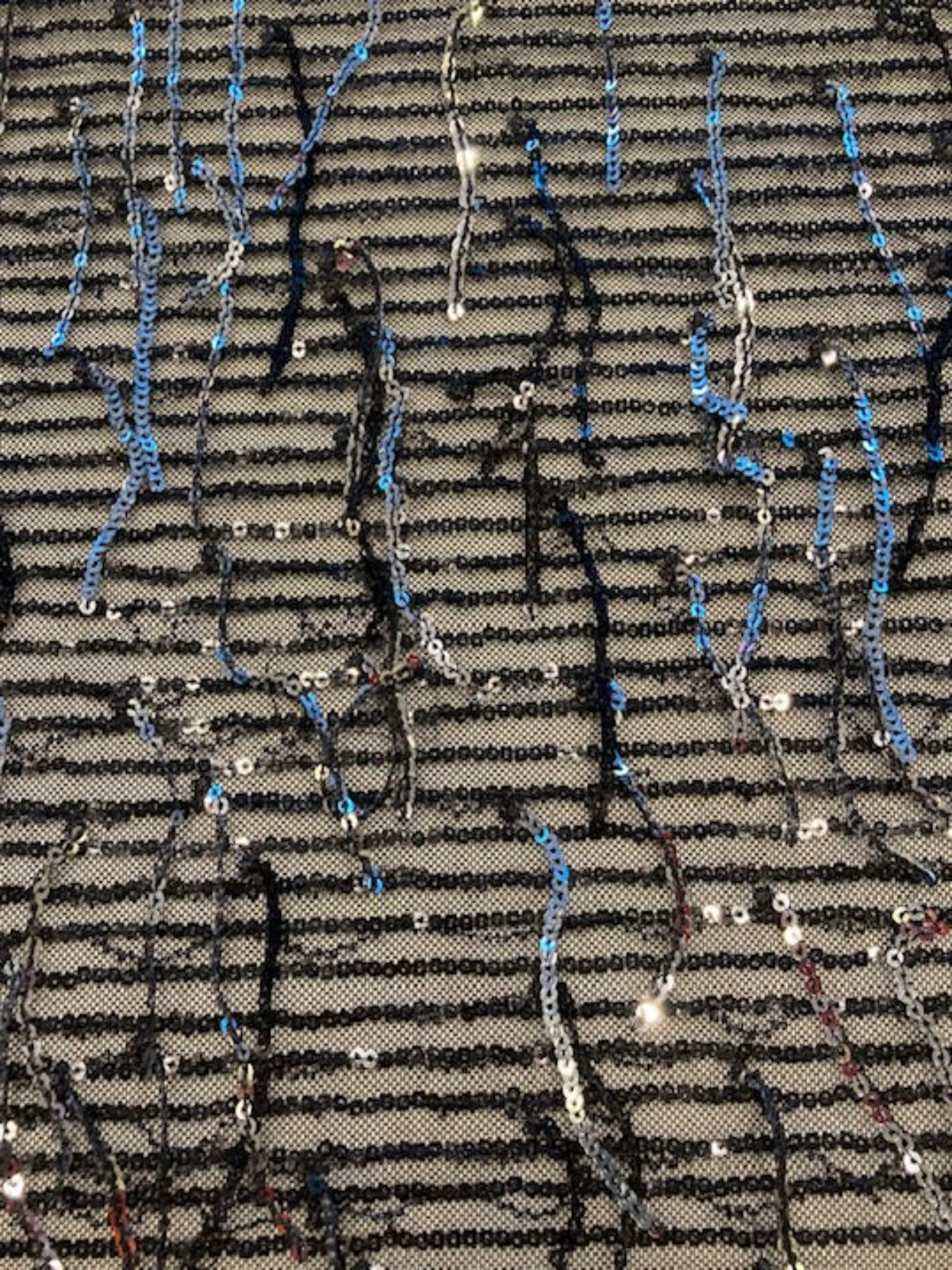 Silver Sequin Tassel on Black Stretch Tulle. Tassels run across the piece.