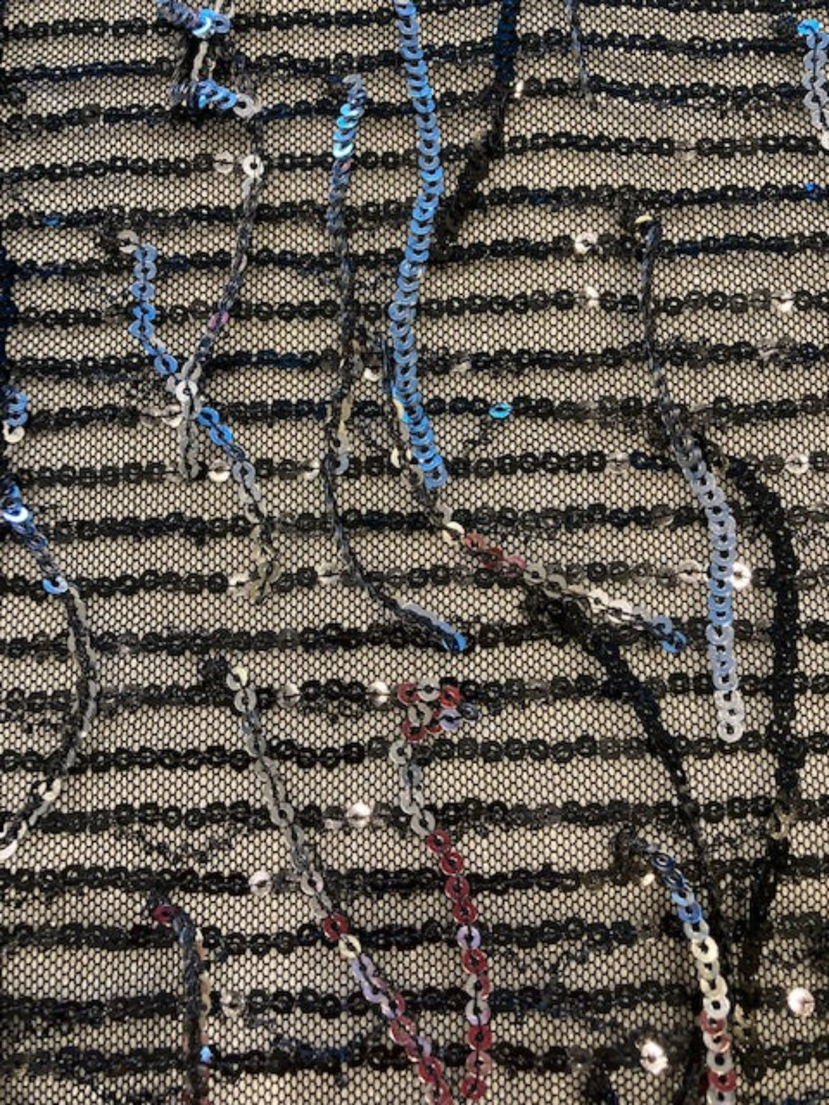 Silver Sequin Tassel on Black Stretch Tulle. Tassels run across the piece.