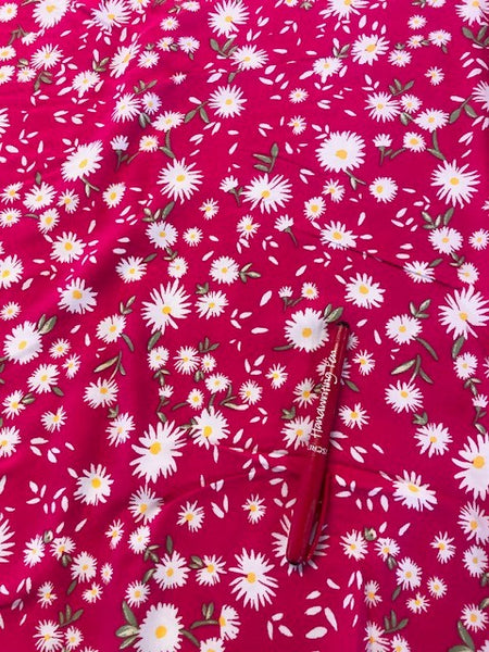 Daisies on pink/Red Viscose. 110g/m2, 100% Viscose. Roll Size: 1.7m