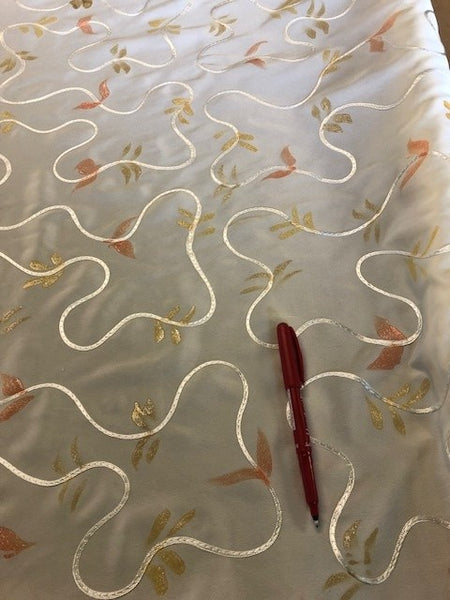Glitter print on Ivory Crepe de Chine With Ribbon Swirl Overlay. 110g/m2, 100% Polyester. Roll Size: 2m