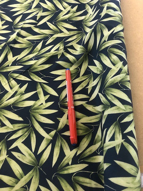 Green on Black Leaf Print on Crepe de Chine. 100g/m2, 100% Polyester. Roll Size: 2m