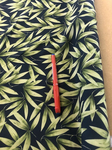 Green on Black Leaf Print on Crepe de Chine. 100g/m2, 100% Polyester. Roll Size: 2m
