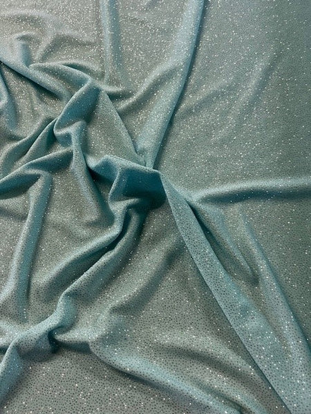 Pastel Turquoise Glitter on Jersey. 220g/m2, 95% Polyester 5% Elastane. Roll Size: 5m