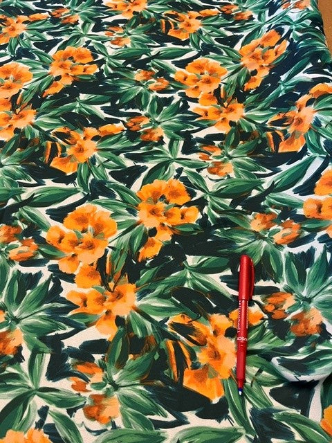 Orange Floral with Green Leaves on Crepe De Chine. 100% Polyester, 115g/m2, 145cm Wide. Roll Size: 4.3m