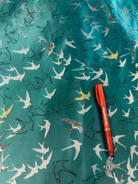 Swallows on Jade Green Jacquard. 100% Polyester, 160g/m2. Roll Size - 1.4m