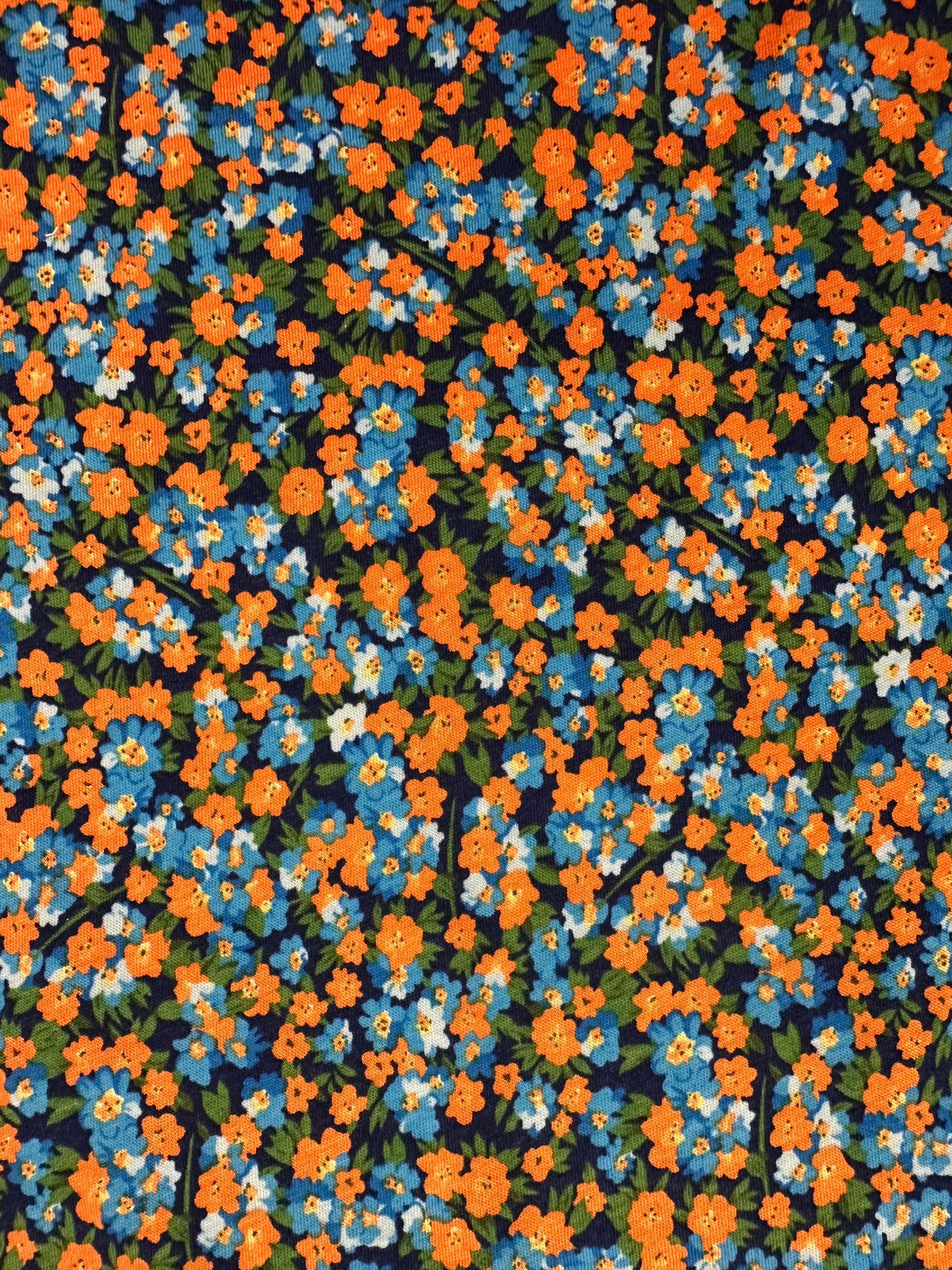 Shop stretch cotton fabric, 178 cm wide, 97% cotton, 3% elastane. Navy base with contemporary flowers in orange, blue, green & white