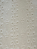 White Daisy Broderie Anglaise Running Along the Fabric