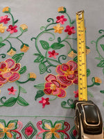 Pink/Gold/Green Embroidery on Sky Blue. Embroidery Runs Along Each Edge of Fabric as a Border