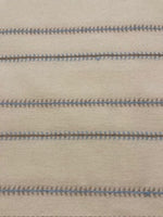 Blue/Burnt Orange Woven Fish Bone Stripe on Ivory. Stripes run across the Fabric.