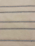 Blue/Burnt Orange Woven Fish Bone Stripe on Ivory. Stripes run across the Fabric.