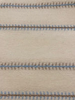 Blue/Burnt Orange Woven Fish Bone Stripe on Ivory. Stripes run across the Fabric.