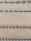 Blue/Burnt Orange Woven Fish Bone Stripe on Ivory. Stripes run across the Fabric.