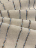 Blue/Burnt Orange Woven Fish Bone Stripe on Ivory. Stripes run across the Fabric.