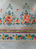 Teal/Gold/Red Embroidery on Sky Blue. Embroidery Runs Along Each Edge of Fabric as a Border