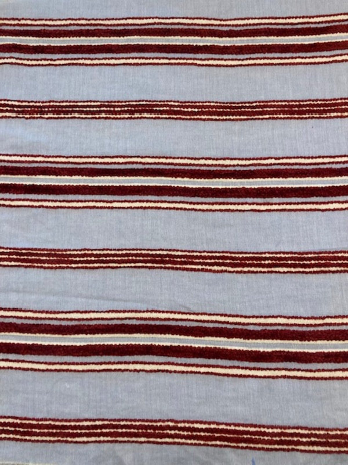 Red Raised Stripe on Sky Blue. Soft Handle,&nbsp; Stripes run across the fabric.