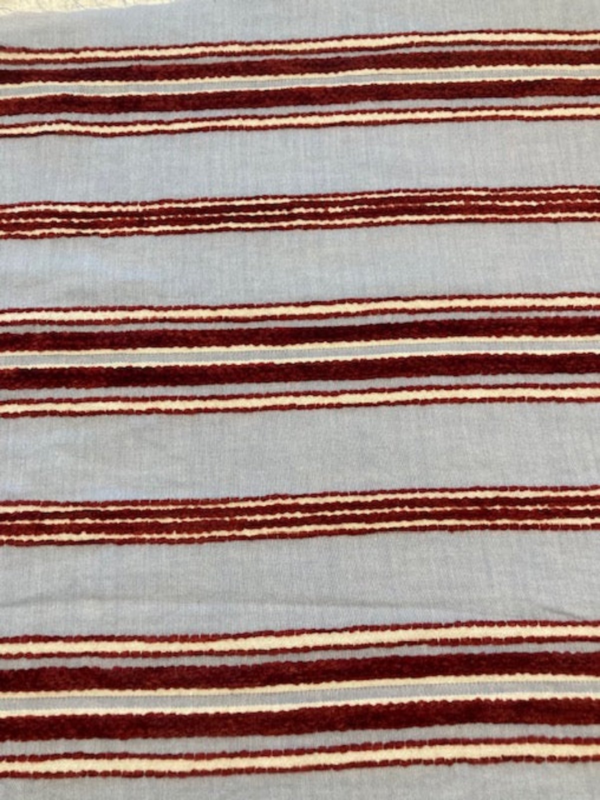 Red Raised Stripe on Sky Blue. Soft Handle,&nbsp; Stripes run across the fabric.