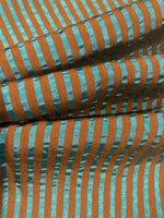 Sea Green/Burnt Orange seersucker Stripe with Sheen on the sea Green. Stripes run across the fabric.