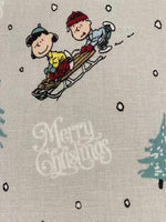 Snoopy on Christmas Sledge on Silver Cotton