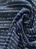 Dashed Stripe on Dark Navy Knit. Stripes Run Across the Fabric