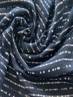 Dashed Stripe on Dark Navy Knit. Stripes Run Across the Fabric