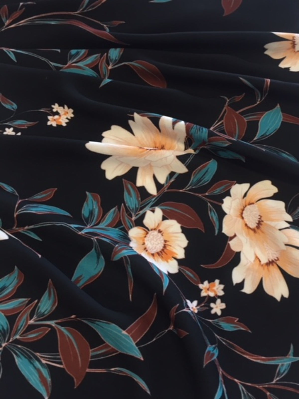 Pale Gold Trailing Flowers on Black Woven Crepe - Deadstock fabric on AmoThreads