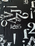 Number and Letters print on Black knit - Deadstock fabric on AmoThreads
