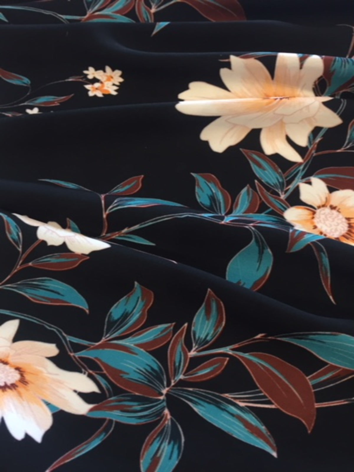 Pale Gold Trailing Flowers on Black Woven Crepe - Deadstock fabric on AmoThreads