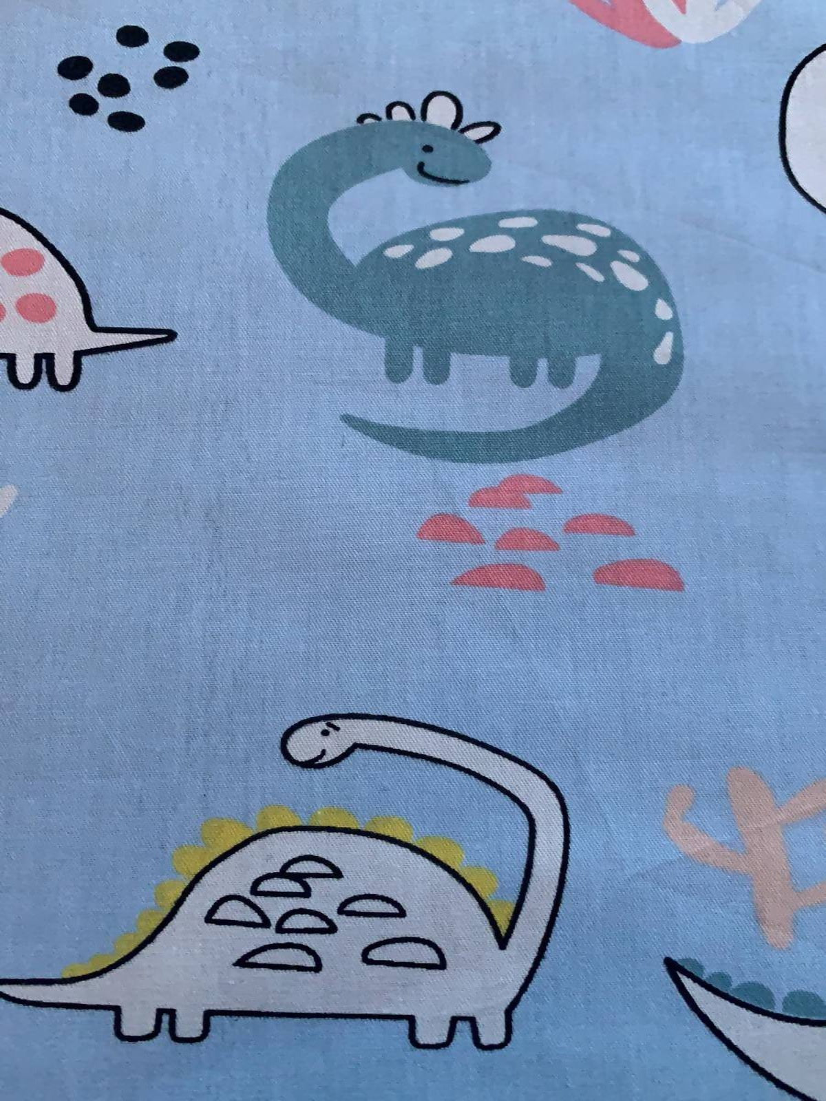 Smiling Dinosaurs on pale Blue Cotton Sateen - Deadstock fabric on AmoThreads
