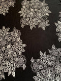 White placement flower print on black knit - Deadstock fabric on AmoThreads