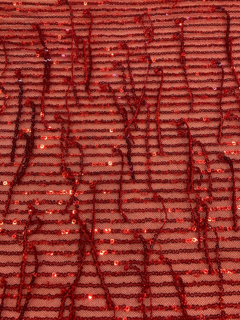Red Sequin Tassel on Red Stretch Tulle. Tassels run across the piece.