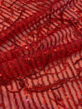 Red Sequin Tassel on Red Stretch Tulle. Tassels run across the piece.