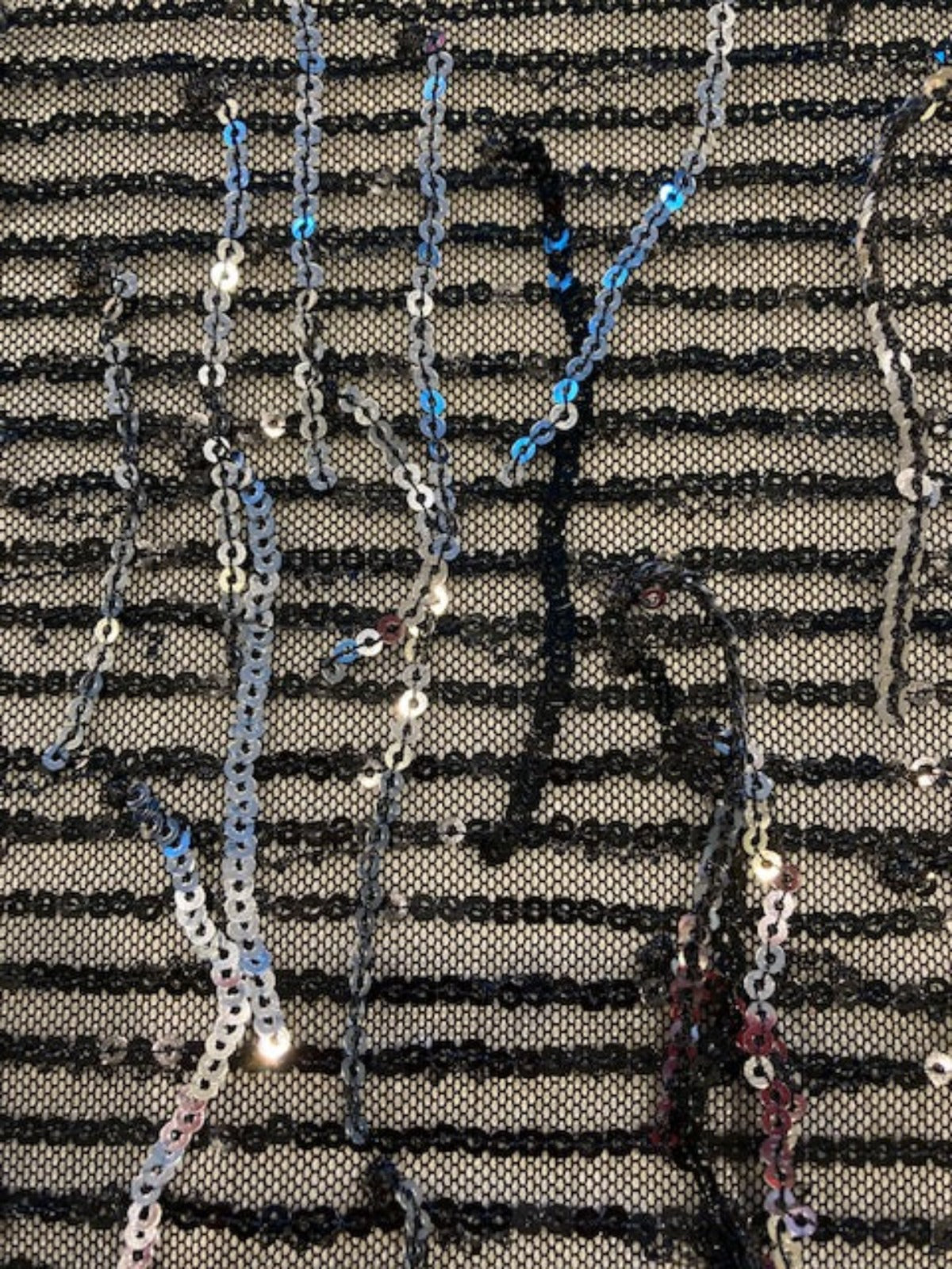 Silver Sequin Tassel on Black Stretch Tulle. Tassels run across the piece.