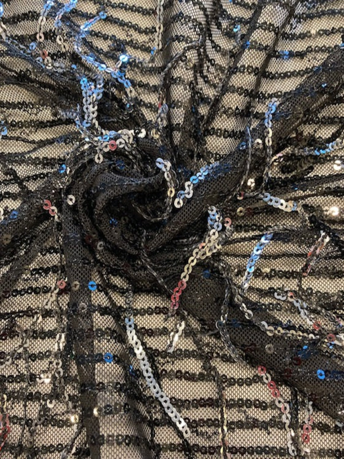 Silver Sequin Tassel on Black Stretch Tulle. Tassels run across the piece.
